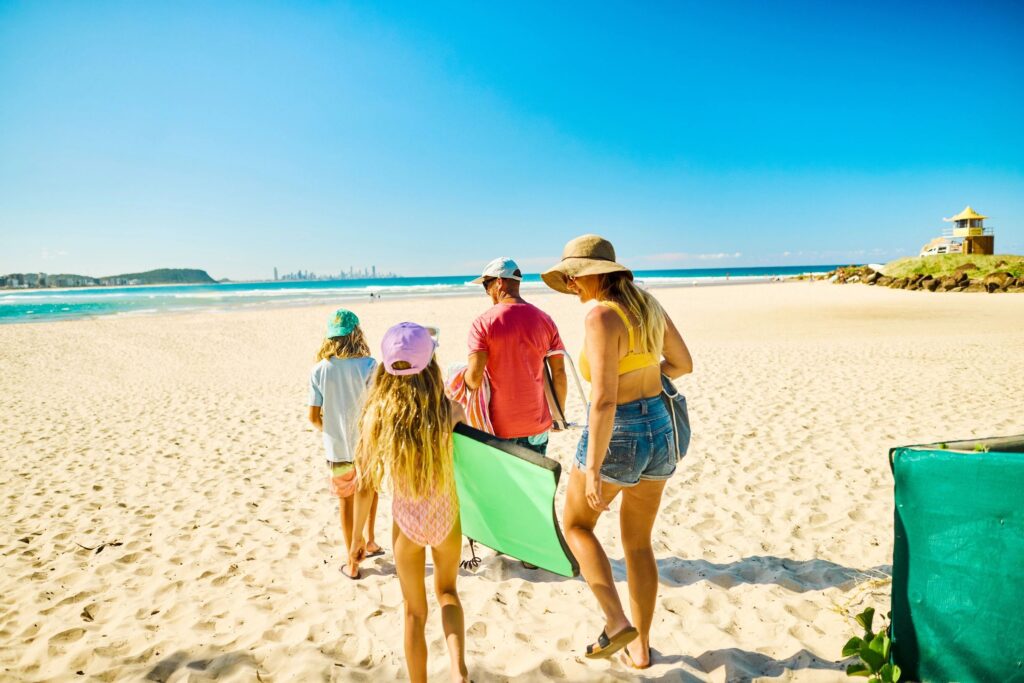 families using wagons on the beach